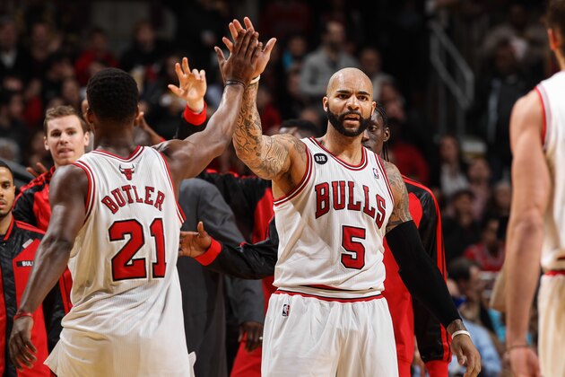 CHICAGO, IL - MARCH 24: Teammates Jimmy Butler #21 and Carlos Boozer #5 of the Chicago Bulls high five during a game against the Indiana Pacers on March 24, 2014 at the United Center in Chicago, Illinois. NOTE TO USER: User expressly acknowledges and agrees that, by downloading and or using this Photograph, user is consenting to the terms and conditions of the Getty Images License Agreement. Mandatory Copyright Notice: Copyright 2013 NBAE (Photo by Gary Dineen/NBAE via Getty Images)