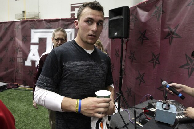 Texas A&M quarterback Johnny Manziel leaves the McFerrin Athletic Center after pro day for NFL football representatives in College Station, Texas, Thursday, March 27, 2014. (AP Photo/Patric Schneider)
