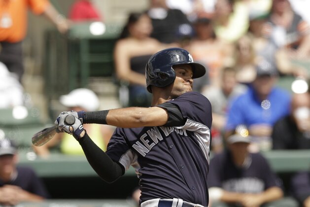 New York Yankees' Mason Williams bats during a spring exhibition baseball game against the Baltimore Orioles in Sarasota, Fla., Saturday, March 15, 2014. (AP Photo/Carlos Osorio)