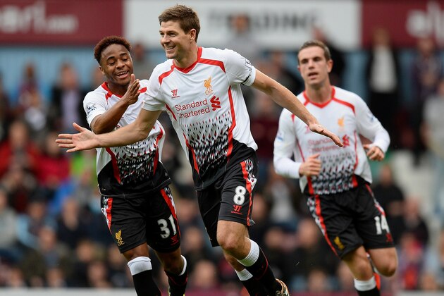 LONDON, ENGLAND - APRIL 06:  Steven Gerrard (C)of Liverpool celebrates with teammate Raheem Sterling (L) after scoring the opening goal from the penalty spot during the Barclays Premier League match between West Ham United and Liverpool at Boleyn Ground on April 6, 2014 in London, England.  (Photo by Mike Hewitt/Getty Images)