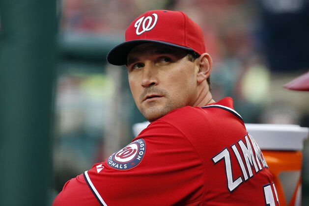 Washington Nationals third baseman Ryan Zimmerman (11) pauses in the dugout during a baseball game against the Atlanta Braves at Nationals Park Saturday, April 5, 2014, in Washington. (AP Photo/Alex Brandon)