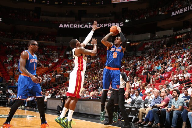 MIAMI, FL - APRIL 6: J.R. Smith #8 of the New York Knicks shoots over Mario Chalmers #15 of the Miami Heat during a game on April 6, 2014 at American Airlines Arena in Miami, Florida.  NOTE TO USER: User expressly acknowledges and agrees that, by downloading and or using this photograph, User is consenting to the terms and conditions of the Getty Images License Agreement. Mandatory Copyright Notice: Copyright 2014 NBAE  (Photo by Nathaniel S. Butler/NBAE via Getty Images)
