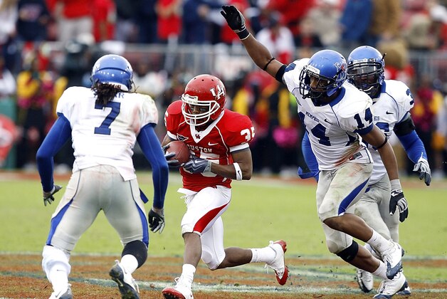 Houston's Tyron Carrier runs between Memphis' Alton Starr and DeRon Furr (14) during the second quarter of an NCAA college football game Saturday, Nov. 21, 2009, in Houston. (AP Photo/Bob Levey)