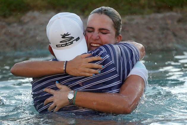 RANCHO MIRAGE, CA - APRIL 06:  Lexi  Thompson celebrates with father Scotti Thompson after taking the leap into Poppie's Pond after her victory during the final round of the Kraft Nabisco Championship at Mission Hills Country Club on April 6, 2014 in Rancho Mirage, California.  (Photo by Stephen Dunn/Getty Images)