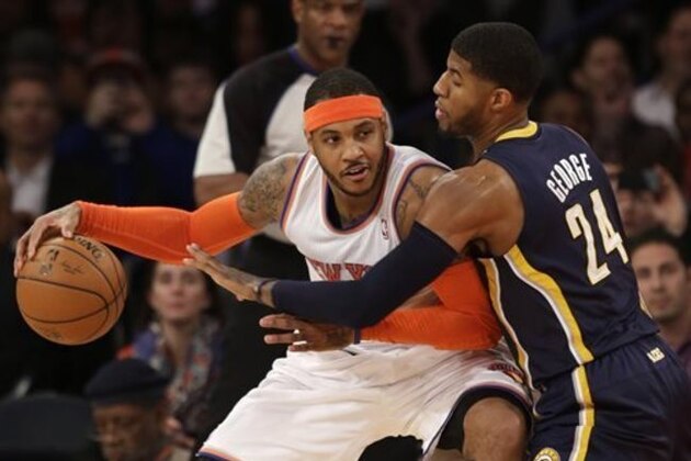 New York Knicks' Carmelo Anthony, left, tries to move around Indiana Pacers' Paul George during the first half of an NBA basketball game at Madison Square Garden on Wednesday, March 19, 2014, in New York. (AP Photo/Seth Wenig)