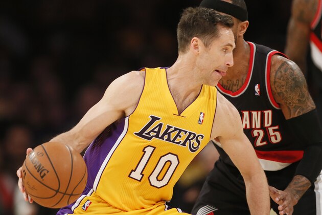 Los Angeles Lakers guard Steve Nash, left, drives around Portland Trail Blazers guard Mo Williams during the first half of an NBA basketball game in Los Angeles, Tuesday, April 1, 2014. (AP Photo/Danny Moloshok)