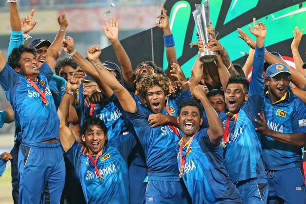 DHAKA, BANGLADESH - APRIL 06:  Lasith Malinga of Sri Lanka and his team celebrate with the trophy on the podium after winning the Final of the ICC World Twenty20 Bangladesh 2014 between India and Sri Lanka at Sher-e-Bangla Mirpur Stadium on April 4, 2014 in Dhaka, Bangladesh.  (Photo by Scott Barbour/Getty Images)