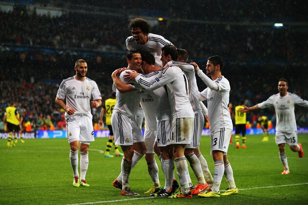MADRID, SPAIN - APRIL 02: Cristiano Ronaldo of Real Madrid celebrates scoring his goal with team mates during the UEFA Champions League Quarter Final first leg match between Real Madrid and Borussia Dortmund at Estadio Santiago Bernabeu on April 2, 2014 in Madrid, Spain. (Photo by Clive Rose/Getty Images) MADRID, SPAIN - APRIL 02: Cristiano Ronaldo of Real Madrid celebrates scoring his goal with team mates during the UEFA Champions League Quarter Final first leg match between Real Madrid and Borussia Dortmund at Estadio Santiago Bernabeu on April 2, 2014 in Madrid, Spain. (Photo by Clive Rose/Getty Images)