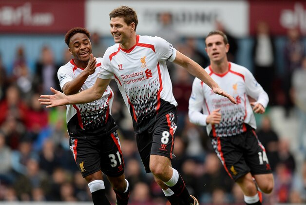 LONDON, ENGLAND - APRIL 06:  Steven Gerrard (C)of Liverpool celebrates with teammate Raheem Sterling (L) after scoring the opening goal from the penalty spot during the Barclays Premier League match between West Ham United and Liverpool at Boleyn Ground on April 6, 2014 in London, England.  (Photo by Mike Hewitt/Getty Images)