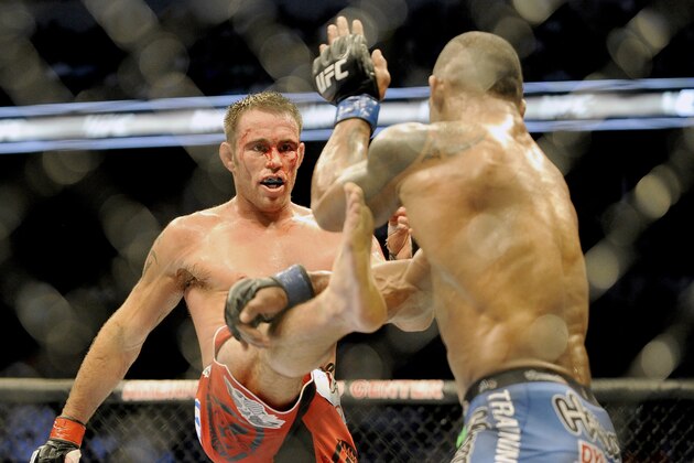 Jake Shields, left, tries to land a kick on Hector Lombard during a UFC 171 mixed martial arts welterweight bout on Saturday, March. 15, 2014, in Dallas. Lombard won by decision. (AP Photo/Matt Strasen)