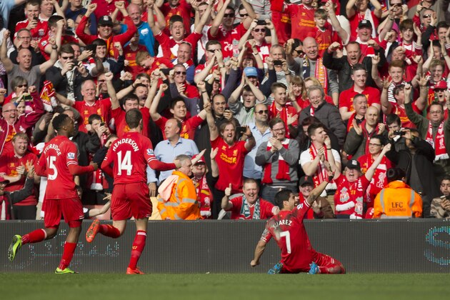 Liverpool's Luis Suarez , right, celebrates after scoring against Tottenham during their English Premier League soccer match at Anfield Stadium, Liverpool, England, Sunday March 30, 2014. (AP Photo/Jon Super)