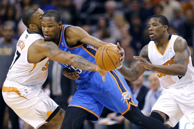 Oklahoma City Thunder forward Kevin Durant, center, collides with Phoenix Suns forward P.J. Tucker (17) during the first half of an NBA basketball game as Suns' Eric Bledsoe watches on Sunday, April 6, 2014, in Phoenix. The Suns won 122-115. (AP Photo/Matt York) Oklahoma City Thunder forward Kevin Durant, center, collides with Phoenix Suns forward P.J. Tucker (17) during the first half of an NBA basketball game as Suns' Eric Bledsoe watches on Sunday, April 6, 2014, in Phoenix. The Suns won 122-115. (AP Photo/Matt York)