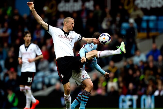 BIRMINGHAM, ENGLAND - APRIL 05: Brede Hangeland (L) of Fulham battles with Grant Holt of Aston Villa during the Barclays Premier League match between Aston Villa and Fulham at Villa Park on April 5, 2014 in Birmingham, England.  (Photo by Ben Hoskins/Getty Images)