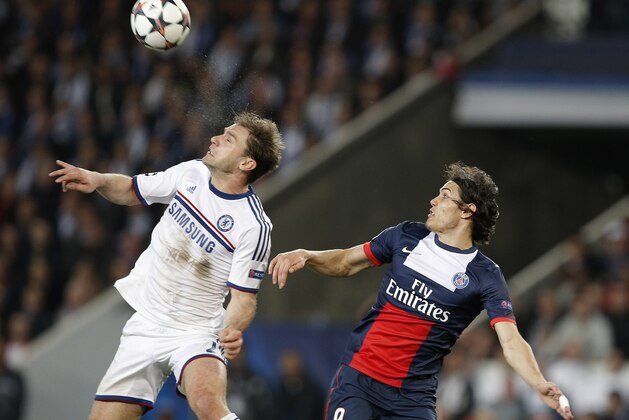 Chelsea's Branislav Ivanovic, left, wins a header in front of PSG's Edinson Cavani during the Champions League quarterfinal first leg soccer match between PSG and Chelsea, at the Parc des Princes stadium, in Paris, Wednesday, April 2, 2014. (AP Photo/Christophe Ena)