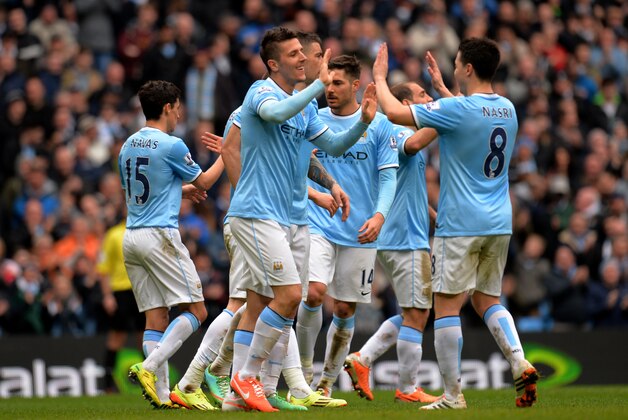 MANCHESTER, ENGLAND - APRIL 05:  Stevan Jovetic of Manchester City is congratulated by teammate Sami Nasri after scoring his team's fourth goal during the Barclays Premier League match between Manchester City and Southampton at Etihad Stadium on April 5, 2014 in Manchester, England.  (Photo by Shaun Botterill/Getty Images)