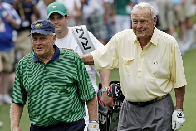 Jack Nicklaus, left, walks with Arnold Palmer on the second hole during the par 3 competition at the Masters golf tournament Wednesday, April 4, 2012, in Augusta, Ga. (AP Photo/David J. Phillip)