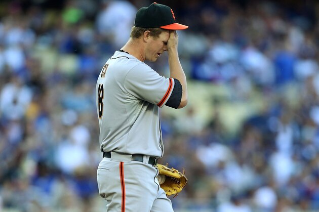 LOS ANGELES, CA - APRIL 06:  Pitcher Matt Cain #18 of the San Francisco Giants wipes his brow after giving up a home run to Hanley Ramirez (not pictured) of the Los Angeles Dodgers (not in photo) in the fourth inning during the MLB game at Dodger Stadium on April 6, 2014 in Los Angeles, California.  (Photo by Victor Decolongon/Getty Images)