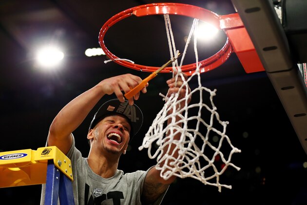 NEW YORK, NY - MARCH 30:  Shabazz Napier #13 of the Connecticut Huskies cuts down the net after defeating the Michigan State Spartans to win the East Regional Final of the 2014 NCAA Men's Basketball Tournament at Madison Square Garden on March 30, 2014 in New York City.  (Photo by Elsa/Getty Images)