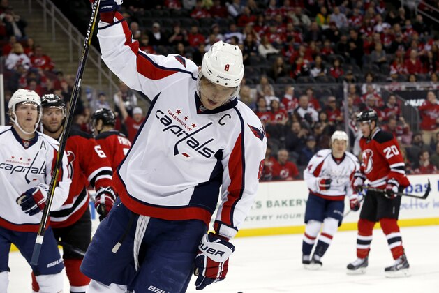Washington Capitals right wing Alex Ovechkin, of Russia, celebrates after scoring a goal against the New Jersey Devils during the first period of an NHL hockey game, Friday, April 4, 2014, in Newark, N.J. (AP Photo/Julio Cortez)