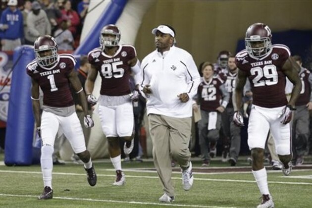 Texas A&M head coach Kevin Sumlin leads his team onto the field in the first half of the Chick-fil-A Bowl NCAA college football game against DukeTuesday, Dec. 31, 2013, in Atlanta. (AP Photo/John Bazemore)