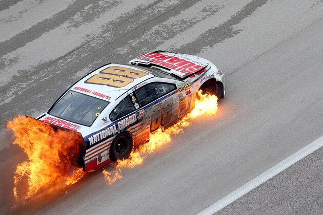 FORT WORTH, TX - APRIL 07:  Dale Earnhardt Jr., driver of the #88 National Guard Chevrolet, crashes early in the NASCAR Sprint Cup Series Duck Commander 500 at Texas Motor Speedway on April 7, 2014 in Fort Worth, Texas.  (Photo by Nick Laham/Getty Images for Texas Motor Speedway)