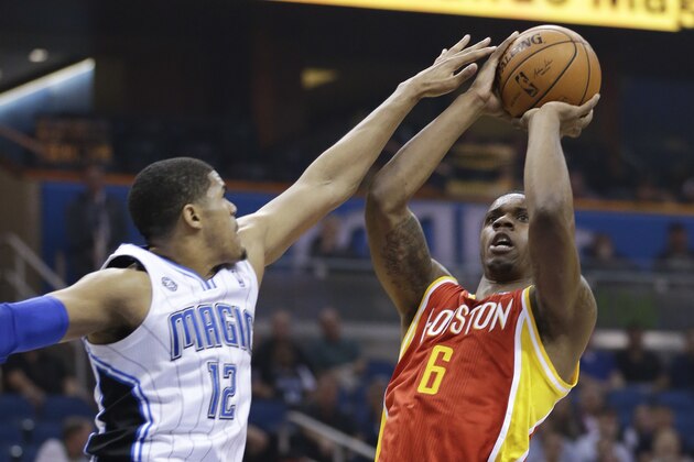 Houston Rockets' Terrence Jones (6) takes a shot over Orlando Magic's Tobias Harris (12) during the first half of an NBA basketball game in Orlando, Fla., Wednesday, March 5, 2014. (AP Photo/John Raoux)