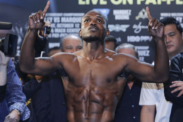 Timothy Bradley poses for photos while standing on the scale for his WBO welterweight title defense fight against Juan Manuel Marquez, Friday, Oct. 11, 2013, in Las Vegas. Bradley will defend his belt against Marquez on Saturday. (AP Photo/Julie Jacobson)