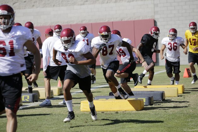 Southern California football players run through drills during NCAA college football practice on Tuesday, Aug. 6, 2013, in Los Angeles. (AP Photo/Jae C. Hong) Southern California football players run through drills during NCAA college football practice on Tuesday, Aug. 6, 2013, in Los Angeles. (AP Photo/Jae C. Hong)