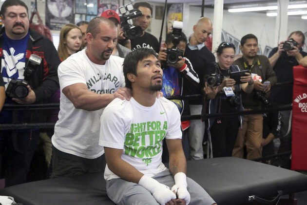 Manny Pacquiao receives a brief massage from Steve Fernandez on Wednesday April 2, 2014, in Los Angeles. Pacquiao is scheduled to fight Timothy Bradley April 12 in a WBO welterweight title bout. (AP Photo/Nick Ut)