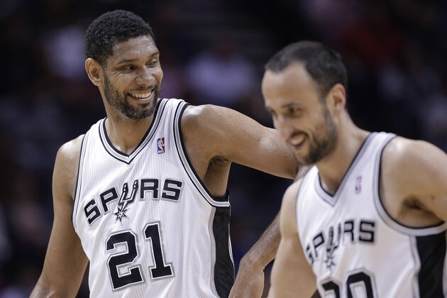 San Antonio Spurs' Tim Duncan (21) celebrates with Manu Ginobili (20) during the second half of an NBA basketball game against the Denver Nuggets, Wednesday, March 26, 2014, in San Antonio. San Antonio won 108-103. (AP Photo/Eric Gay)