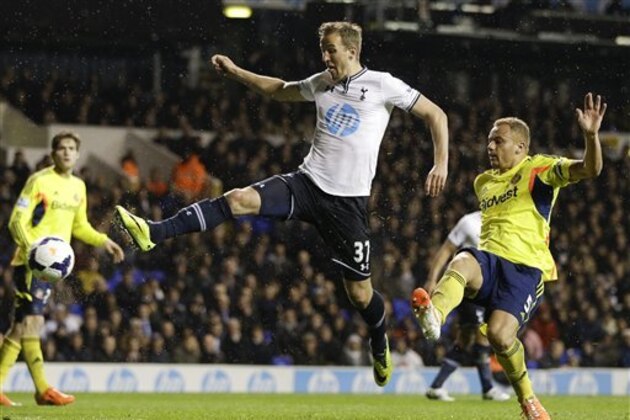 Tottenham's Harry Kane, left, scores a goal in front of Sunderland's Wes Brown, right, during the English Premier League soccer match between Tottenham Hotspur and Sunderland at White Hart Lane stadium in London, Monday, April 7, 2014. (AP Photo/Kirsty Wigglesworth)