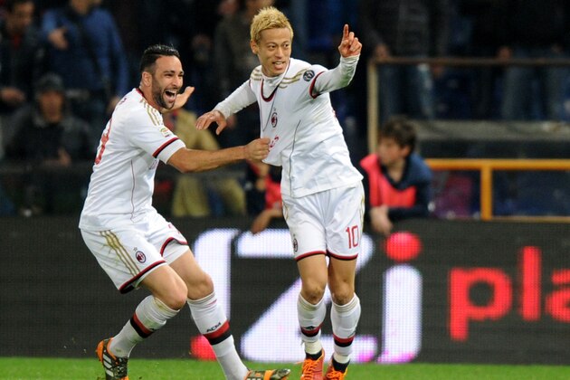AC Milan's Keisuke Honda, right, celebrates after scoring with his teammate Adil Rami during a Serie A soccer match between Genoa and AC Milan, in Genoa's Luigi Ferraris Stadium,  Italy, Monday, April  7, 2014. (AP Photo/Tano Pecoraro)