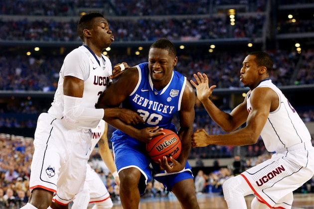 ARLINGTON, TX - APRIL 07: Julius Randle #30 of the Kentucky Wildcats goes to the basket as Amida Brimah #35 and Lasan Kromah #20 of the Connecticut Huskies defend during the NCAA Men's Final Four Championship at AT&T Stadium on April 7, 2014 in Arlington, Texas.  (Photo by Ronald Martinez/Getty Images)