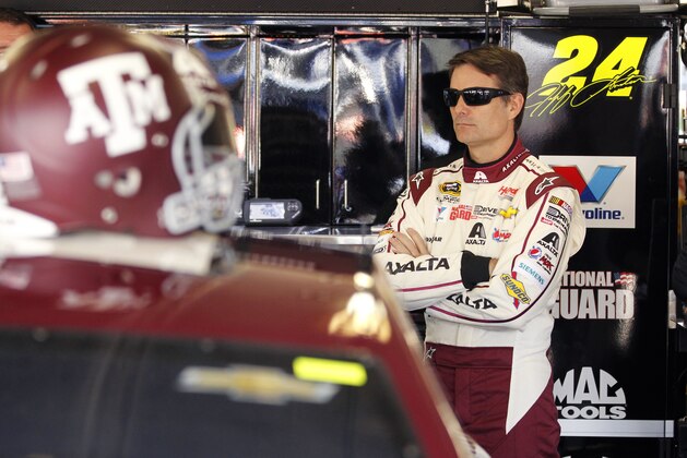 Jeff Gordon stands in the garage during a practice session for the NASCAR Sprint Cup Series auto race at Texas Motor Speedway in Fort Worth, Texas, Friday, April 4, 2014. (AP Photo/Mike Stone)