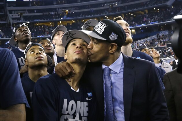 Connecticut head coach Kevin Ollie, right, kisses guard Shabazz Napier on the cheek after their 60-54 victory over Kentucky in the NCAA Final Four tournament college basketball championship game Monday, April 7, 2014, in Arlington, Texas. (AP Photo/David J. Phillip)
