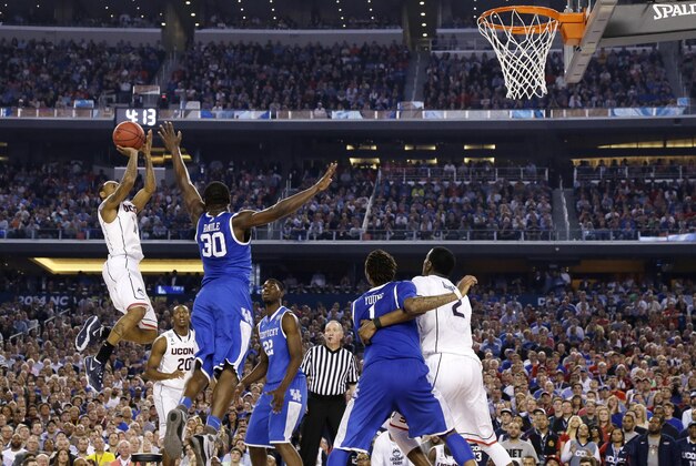 Connecticut guard Ryan Boatright, left, shoots over Kentucky forward Julius Randle (30) during the second half of the NCAA Final Four tournament college basketball championship game Monday, April 7, 2014, in Arlington, Texas. (AP Photo/Eric Gay)