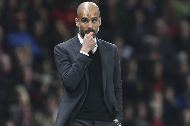 Bayern head coach Pep Guardiola watches the Champions League quarterfinal first leg soccer match between Manchester United and Bayern Munich at Old Trafford Stadium, Manchester, England, Tuesday, April 1, 2014.(AP Photo/Jon Super)