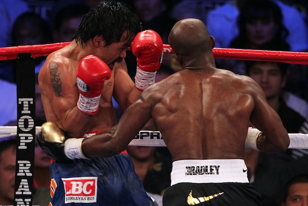 LAS VEGAS, NV - JUNE 09:  (R-L) Timothy Bradley lands a left to the body of Manny Pacquiao during their WBO welterweight title fight at MGM Grand Garden Arena on June 9, 2012 in Las Vegas, Nevada.  (Photo by Jeff Bottari/Getty Images)