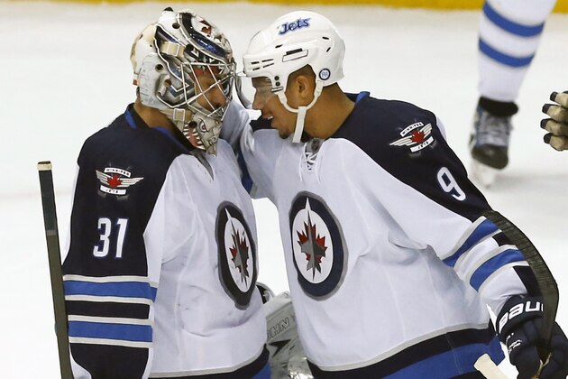 Winnipeg Jets goalie Ondrej Pavelec (31), of the Czech Republic, is congratulated by Winnipeg Jets wing Evander Kane (9) after a NHL hockey game against the Detroit Red Wings in Detroit, Tuesday, Nov. 12, 2013. Winnipeg won 3-2 in a shootout. (AP Photo/Paul Sancya)