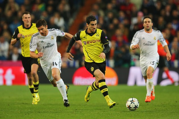 MADRID, SPAIN - APRIL 02:  Henrikh Mkhitaryan of Borussia Dortmund goes past Xabi Alonso of Real Madrid during the UEFA Champions League Quarter Final first leg match between Real Madrid and Borussia Dortmund at Estadio Santiago Bernabeu on April 2, 2014 in Madrid, Spain.  (Photo by Clive Rose/Getty Images)