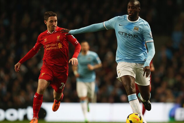 MANCHESTER, ENGLAND - DECEMBER 26:  Yaya Toure of Manchester City is closed down by Joe Allen of Liverpool during the Barclays Premier League match between Manchester City and Liverpool at Etihad Stadium on December 26, 2013 in Manchester, England.  (Photo by Jan Kruger/Getty Images)