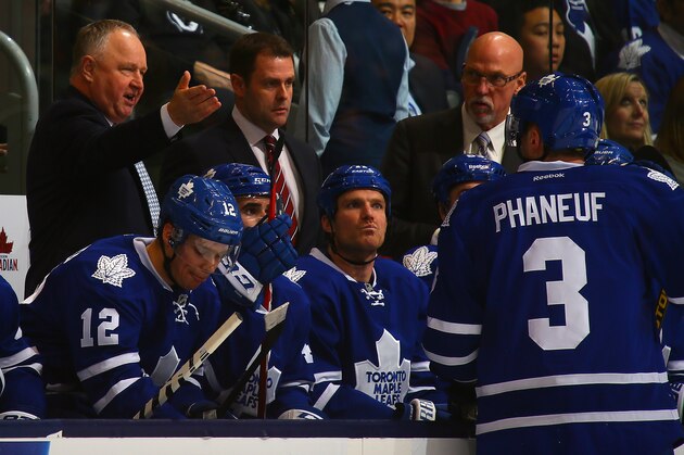 TORONTO, ON - APRIL 3:  Head coach Randy Carlyle of the Toronto Maple Leafs talks to Dion Phaneuf #3 during a break in action against the Boston Bruins during NHL action at the Air Canada Centre April 3, 2014 in Toronto, Ontario, Canada.  (Photo by Abelimages/Getty Images)