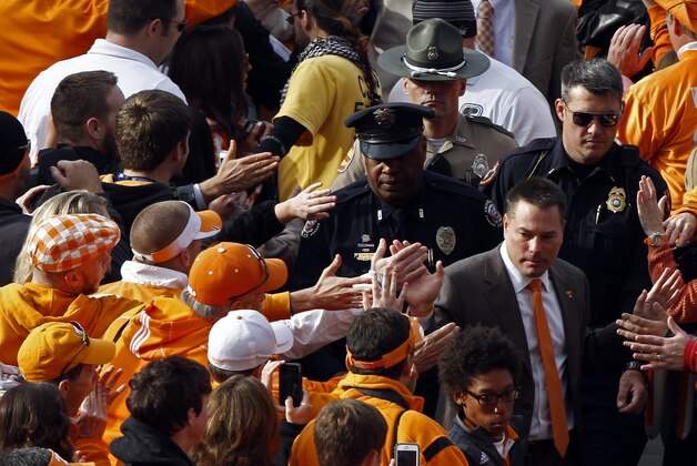 Tennessee coach Butch Jones makes his way through the crowd of fans during the Vol Walk before an NCAA college football game against Aurburn on Saturday, Nov. 9, 2013 in Knoxville, Tenn. (AP Photo/Wade Payne)