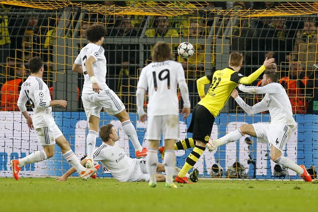 Dortmund's Marco Reus, 2nd right, scores his side's second goal during the Champions League quarterfinal second leg soccer match between Borussia Dortmund and Real Madrid in the Signal Iduna stadium in Dortmund, Germany, Tuesday, April 8, 2014. (AP Photo/Frank Augstein)