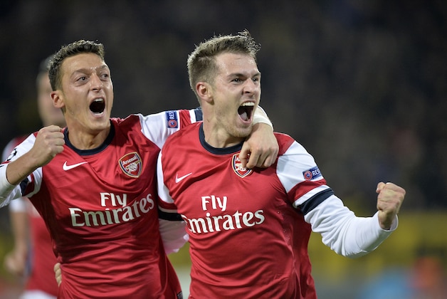 Arsenal's Aaron Ramsey, right, and team mate Mesut Ozil celebrate Ramsey's opening goal during the Champions League group F soccer match between Borussia Dortmund and Arsenal FC in Dortmund, Germany, on Wednesday, Nov. 6, 2013. (AP Photo/Martin Meissner)