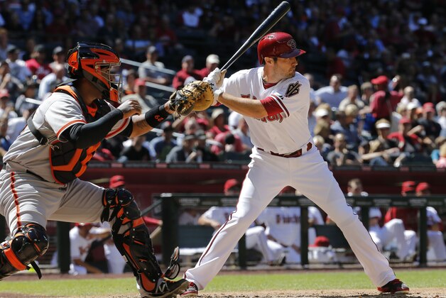 Arizona Diamondbacks' Chris Owings hits as San Francisco Giants catcher Hector Sanchez waits for a pitch out during the fourth inning of an MLB baseball game, Thursday, April 3, 2014,in Phoenix. (AP Photo/Matt York)