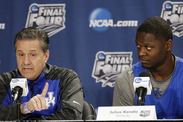 Kentucky head coach John Calipari, left, answers a question as forward Julius Randle looks on during a news conference for the NCAA Final Four tournament college basketball championship game Sunday, April 6, 2014, in Arlington, Texas. Kentucky plays Connecticut in the championship game on Monday, April 7. 2014. (AP Photo/Tony Gutierrez)