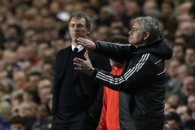 Chelsea's manager Jose Mourinho, right gestures to his team watched by Paris Saint-Germain's coach Laurent Blanc during the Champions League quarterfinal second leg soccer match between Chelsea and Paris Saint Germain at Stamford Bridge stadium in London, Tuesday, April 8, 2014. Chelsea won the game 2-0 and advance to the semifinals. (AP Photo/Matt Dunham).