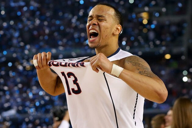 ARLINGTON, TX - APRIL 07:  Shabazz Napier #13 of the Connecticut Huskies celebrates on the court after defeating the Kentucky Wildcats 60-54 in the NCAA Men's Final Four Championship at AT&T Stadium on April 7, 2014 in Arlington, Texas.  (Photo by Ronald Martinez/Getty Images)