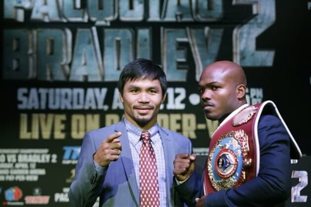 Boxer Manny Pacquiao, of the Phillipines, left, poses for a photo with current WBO World Welterweight champion Timothy Bradley of Indio, Ca., during a press conference,Thursday, Feb. 6, 2014, in New York. The pair will face off in a title fight in Las Vegas, April 12, 2014. (AP Photo/Kathy Willens)
